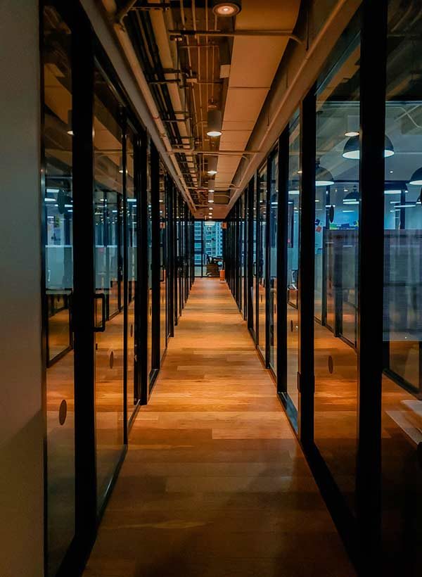 long office hallway tunnel view with gall doors on the sides